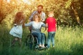 Children run to their disabled mother in the park Royalty Free Stock Photo