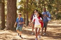 Children Running Ahead Of Parents On Family Hiking Adventure Royalty Free Stock Photo