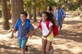 Children Running Ahead Of Parents On Family Hiking Adventure Royalty Free Stock Photo