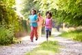 Children Running In Countryside With Father Royalty Free Stock Photo