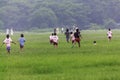 Children running in the park of spring field in casual clothes