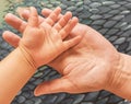 Children`s and adult hand palms up on an abstract background Royalty Free Stock Photo