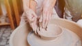 Children`s and adults`s hands together working behind the potter`s wheel Royalty Free Stock Photo