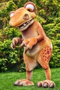 A children `s animator in the form of a dinosaur. Game tyrannosaur. Street photography in nature. A soft orange-coloured toy Royalty Free Stock Photo