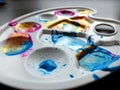 Children`s artists plastic palette with different colors colors on grey background. Concept of art with children, early