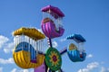 Children`s attraction is quarantined due to Covid-19. Colorful ferris wheel in amusement park on blue sky background. Close-up. Royalty Free Stock Photo