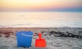 Children`s beach toys - buckets, spade and shovel on sand on a sunny day Royalty Free Stock Photo