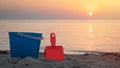 Children`s beach toys - buckets, spade and shovel on sand on a sunny day Royalty Free Stock Photo