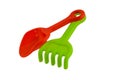 Children`s beach toys, Red spade and Green rake isolated on whit Royalty Free Stock Photo