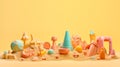 Children\'s beach toys on sand isolated on bright yellow background with copy space for text. Summer vacation or kids holiday