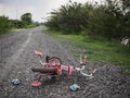 Children`s bicycle and shoe on stone road. missing children co Royalty Free Stock Photo