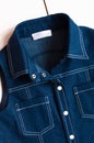 Children`s blue denim dress closeup, details. Pockets, stitching, metal buttons or rivets and collar. Jeans texture, denim jacket Royalty Free Stock Photo