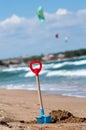 Children`s blue and red shovel, hammered into the sand on the beach Royalty Free Stock Photo