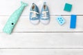 Children`s blue shoes and toys on a white wooden background. Vie Royalty Free Stock Photo