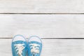 Children`s blue shoes on a white wooden background. flat lay Royalty Free Stock Photo