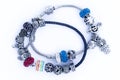 Children`s bracelet with jewelry. A bijouterie set consisting of a necklace and hanging silver earrings with a blue stone.