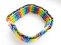 Children`s bright braided wide bracelet made of multi-colored small rubber bands isolated object on a white background