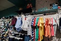 Children`s bright clothes hang on the display in the baby clothing store. Boys section