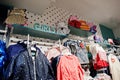 Children`s bright clothes hang on the display in the baby clothing store. Girls section