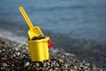 Children's bucket full of pebble with scoop