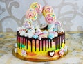 Children`s cake rainbow color on a white background with wood meringue