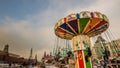 Children`s Carousel at an amusement park in the evening and night illumination. amusement park at night. Outdoor vintage colorful