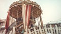 Children`s Carousel at an amusement park in the evening and night illumination. amusement park at night. Outdoor vintage colorful