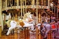 Children`s carousel is decorated with multicolor lights, decorations, a fairground ride with horses for children, the concept of