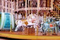 Children`s carousel is decorated with multicolor lights, decorations, a fairground ride with horses for children, the concept of