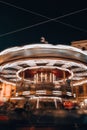 Children's Carousel in the evening and night illumination. Spinning retro carousel. Merry-go-round at night motion blur Royalty Free Stock Photo