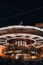 Children's Carousel in the evening and night illumination. Spinning retro carousel. Merry-go-round at night motion blur Royalty Free Stock Photo