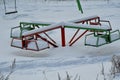 Children`s carousel in the snow