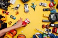 Children`s cars toys for developing baby games on a yellow background Royalty Free Stock Photo