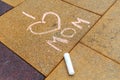 Children's chalk drawing on the ground. I love Mom. Mother's Day concept Royalty Free Stock Photo