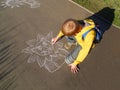 Child drawing with chalk.