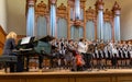 Children`s choir and soloists on stage before the start of the performance.