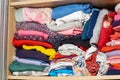 Children`s clothes drawer detail, closeup, detail, lots of children`s clothes stored in the closet, wardrobe, nobody. Folded