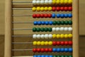 Children`s colorful abacus for counting with multi-colored wooden beads Royalty Free Stock Photo