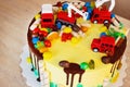 Children`s colorful fondant birthday cake decorated with little cars Royalty Free Stock Photo