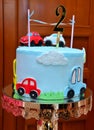 Children`s colorful fondant birthday cake decorated with little cars and number two on the top Royalty Free Stock Photo