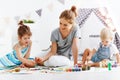 Children`s creativity. mother and children draw paints in play Royalty Free Stock Photo