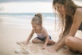 Children`s Day. Mom and baby playing near beach. Royalty Free Stock Photo