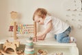 Children`s Day. Sweet funny baby in children room. Scandi style girl room. Child play with educational toys.Early child Royalty Free Stock Photo