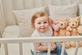 Children`s Day. Sweet funny baby in children room. Scandi style girl room. Child play with educational toys.Early child Royalty Free Stock Photo