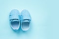 Children's denim sports shoes for boys stands on blue background. Close-up top view. Baby clothes concept. Royalty Free Stock Photo