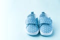 Children's denim sports shoes for boys stands on blue background. Close-up top view. Baby clothes concept. Royalty Free Stock Photo