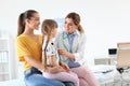 Children`s doctor examining little girl near parent Royalty Free Stock Photo