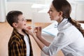 Children`s doctor examining little patient`s throat in clinic Royalty Free Stock Photo