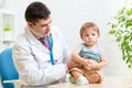 Children's doctor exams infant child with Royalty Free Stock Photo