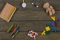 Children`s doctor or pediatrician concept - blank notepad, pills, yellow stethoscope, colorful wooden jigsaw puzzles, Teddy bear